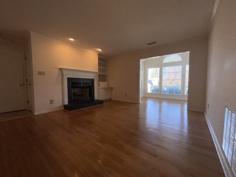A living room with a fireplace and a sliding glass door.