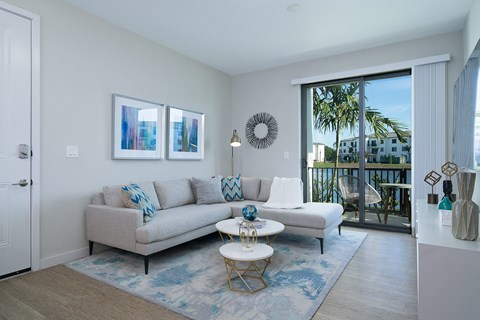 a living room with a couch and a coffee table in front of a sliding glass door