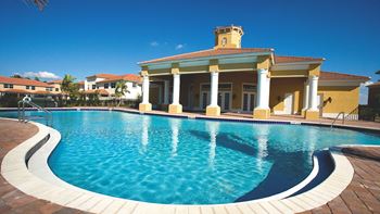 a large swimming pool in front of a building
