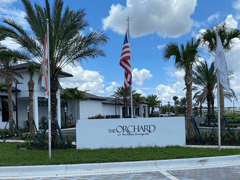 the orchid resort and spa sign in front of palm trees