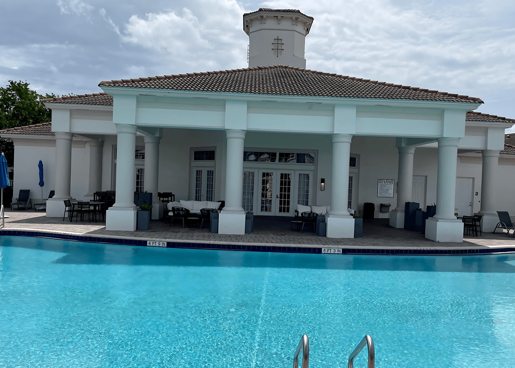 the pool and pavilion of a hotel with a swimming pool