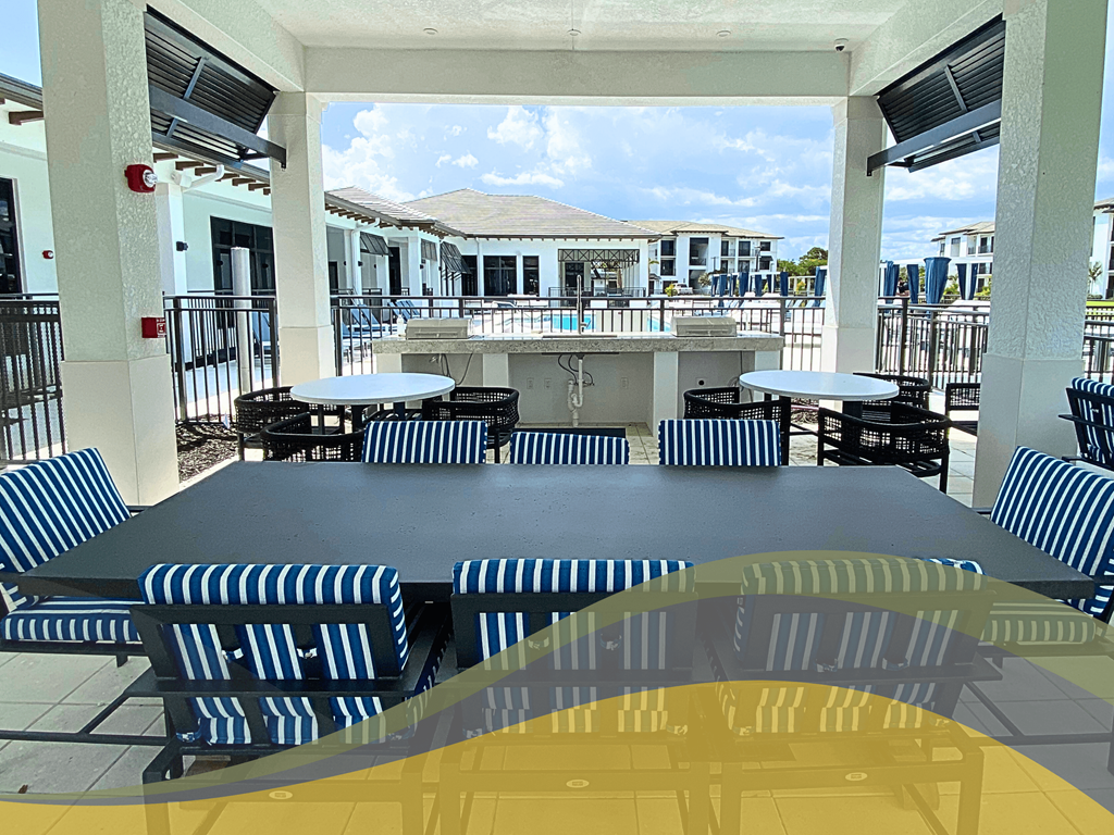 a large patio with tables and chairs and a bar