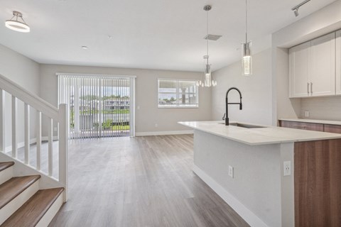 the living room and kitchen of a new home with an open floor plan
