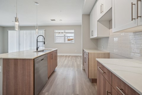 a large kitchen with wooden cabinets and white counter tops a large kitchen with wooden cabinets and white counter tops at The Falls of Portofino Apartment, Florida