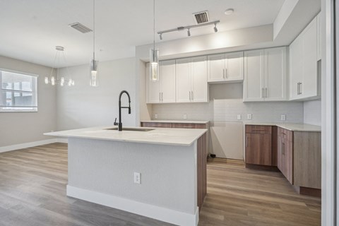 a kitchen with white cabinets and a large white counter top