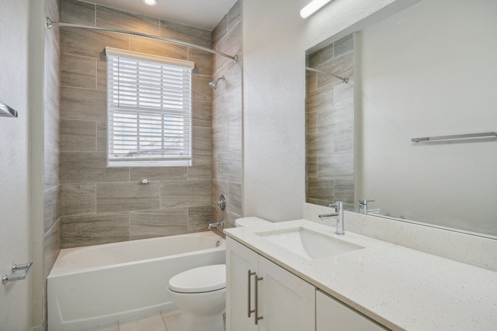 a bathroom with a sink toilet and a bath tub