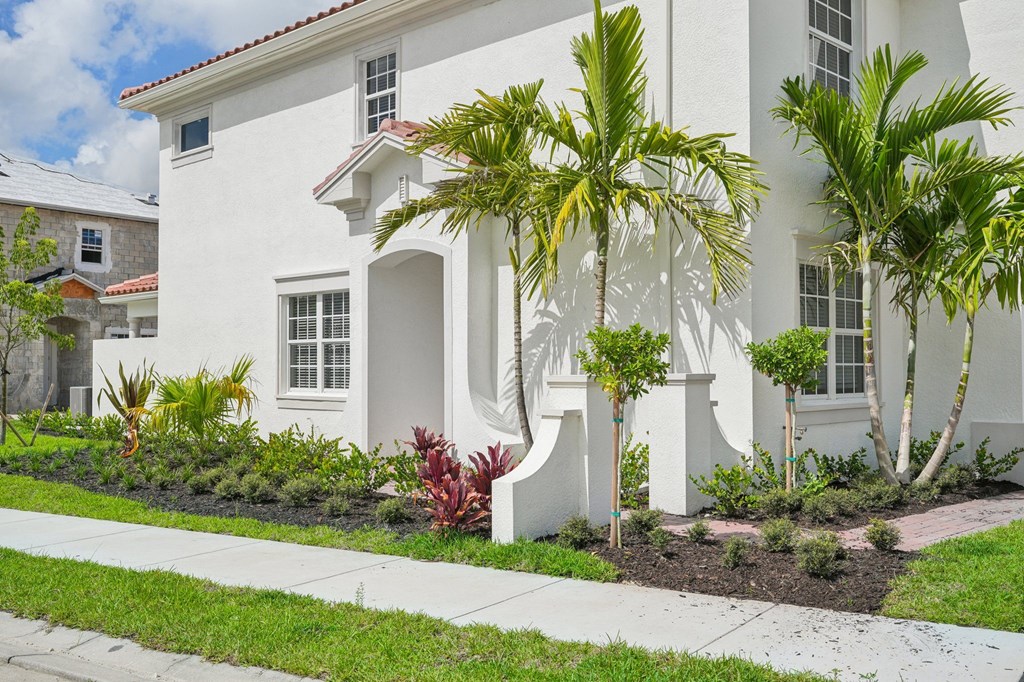 a white house with palm trees in front of it