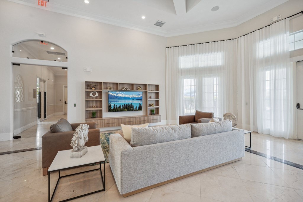 a living room with a couch and a coffee table and a television
