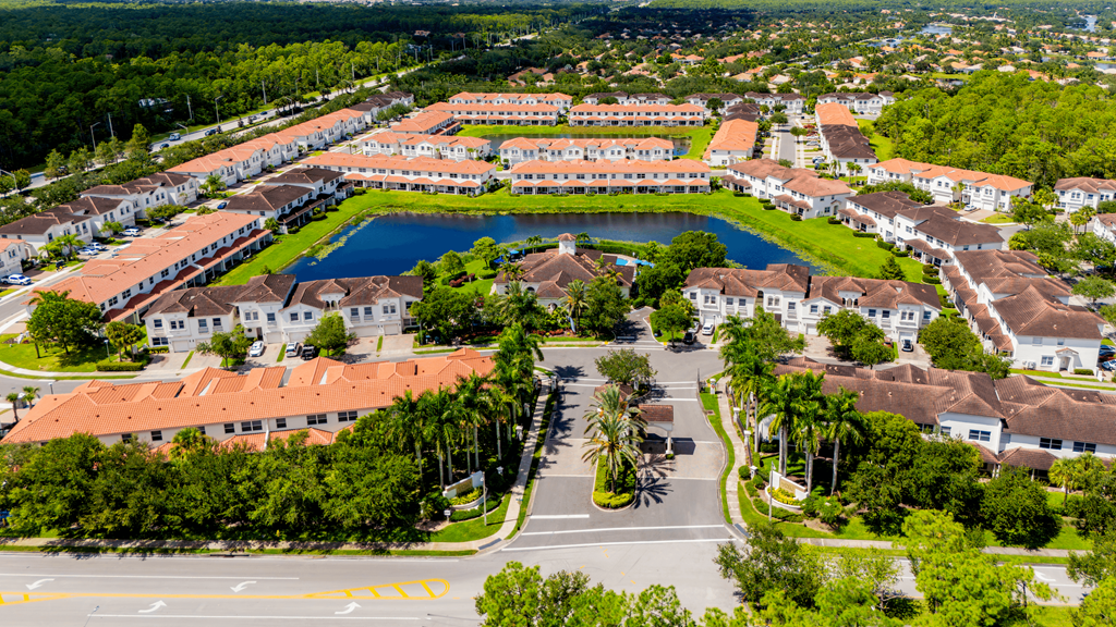 A large building complex with a pool in the middle.