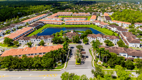 A large building complex with a pool in the middle.
