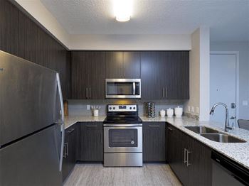 a kitchen with stainless steel appliances and a sink at Icon One Daytona