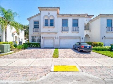 a car parked in a driveway in front of a house