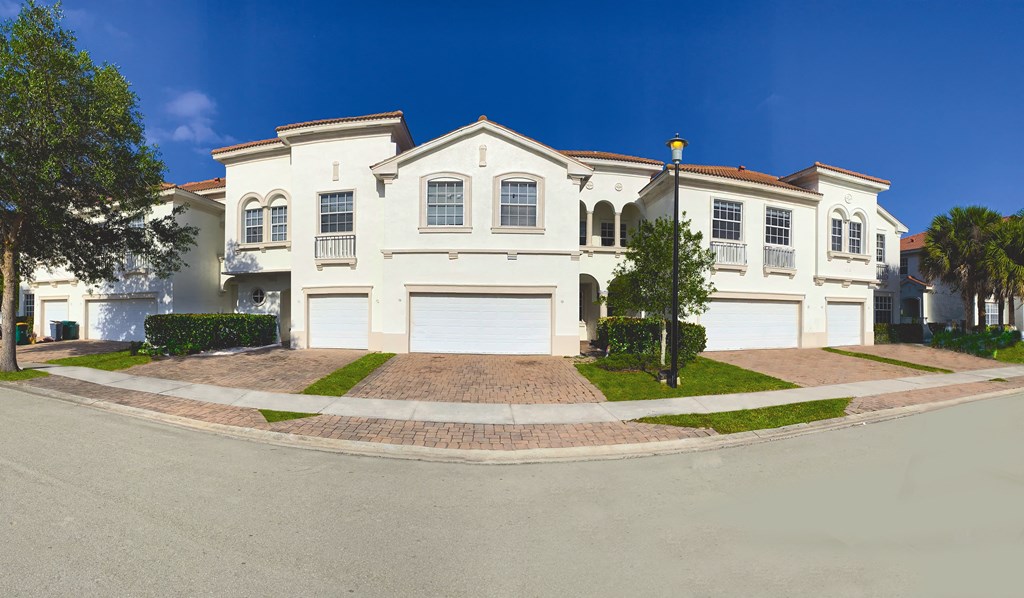 a large white house on the corner of a street