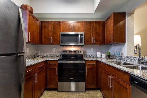 A kitchen with wooden cabinets and stainless steel appliances.