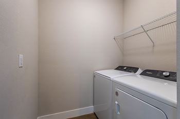 A small laundry room with a washer and dryer.