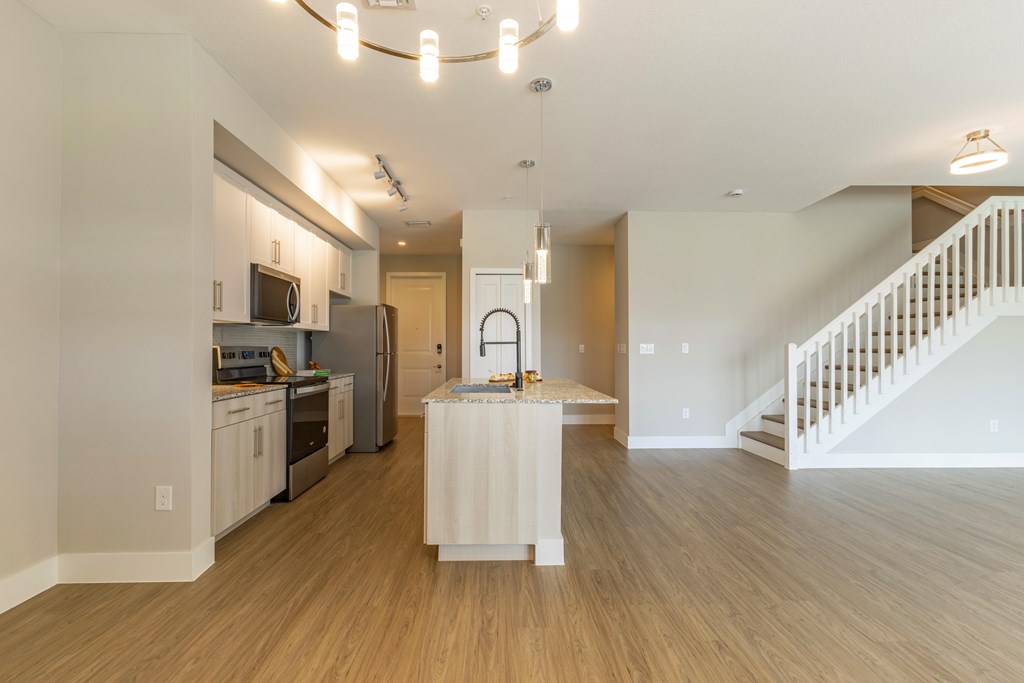A kitchen with a white island in the middle of the room.