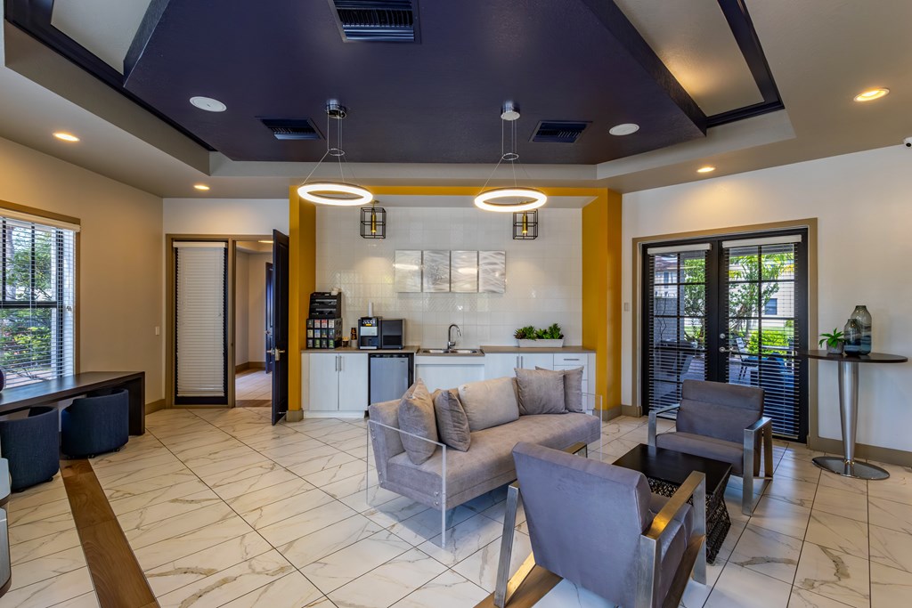A modern living room with a kitchen area in the background.
