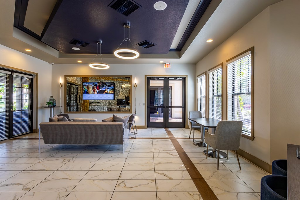 A living room with a grey couch and a television.