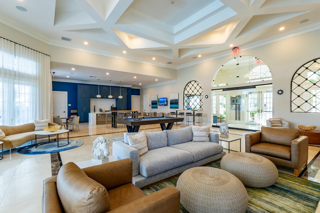 A spacious living room with a variety of seating options and a large window.