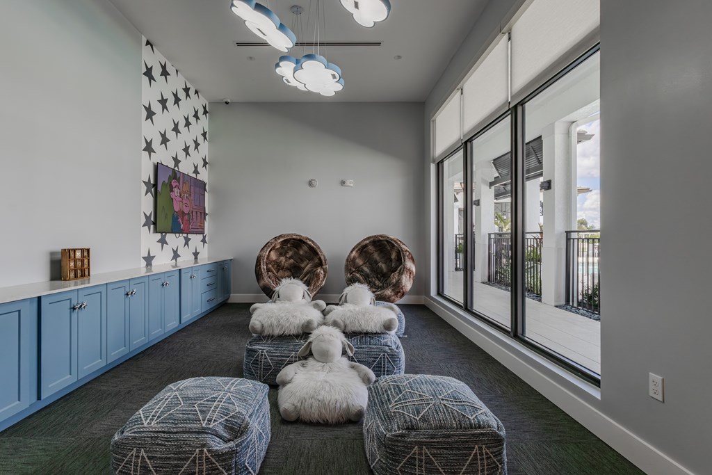 A room with a grey carpet and a white ceiling with lights.