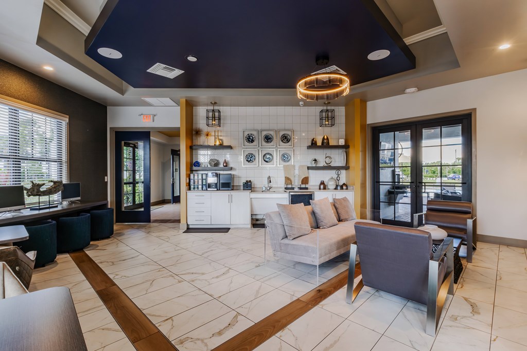 A modern living room with a kitchen area in the background.