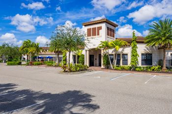 A building with a parking lot in front of it.