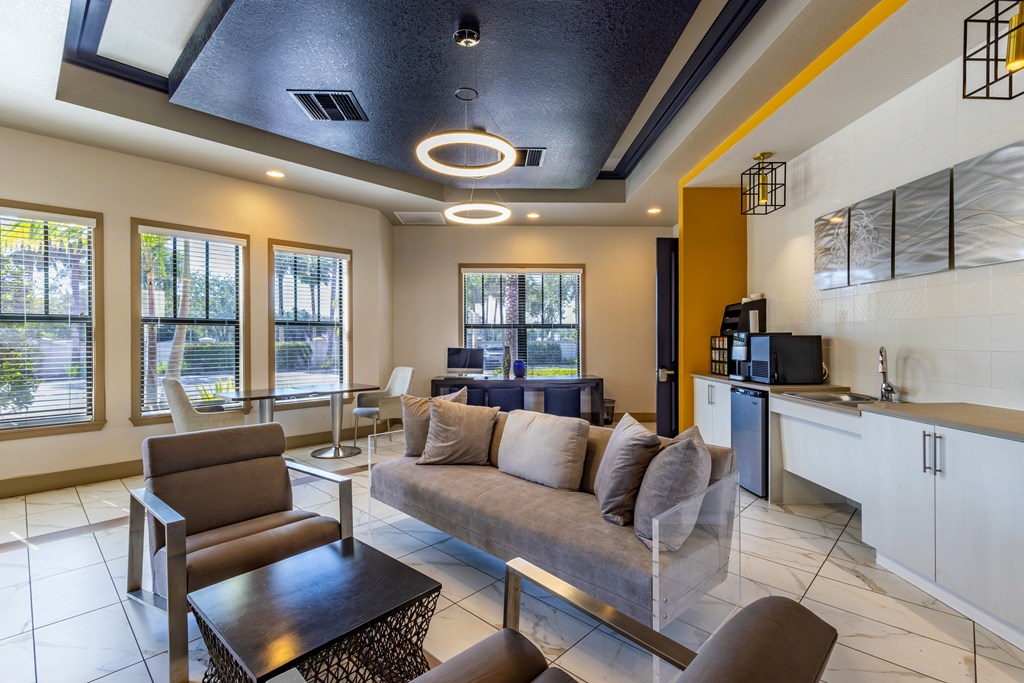 A modern living room with a brown sofa and a glass coffee table.