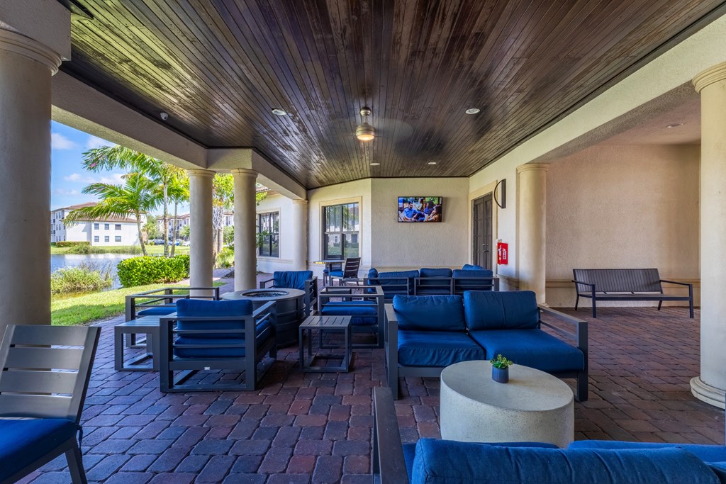 A patio with blue couches and chairs is shown.