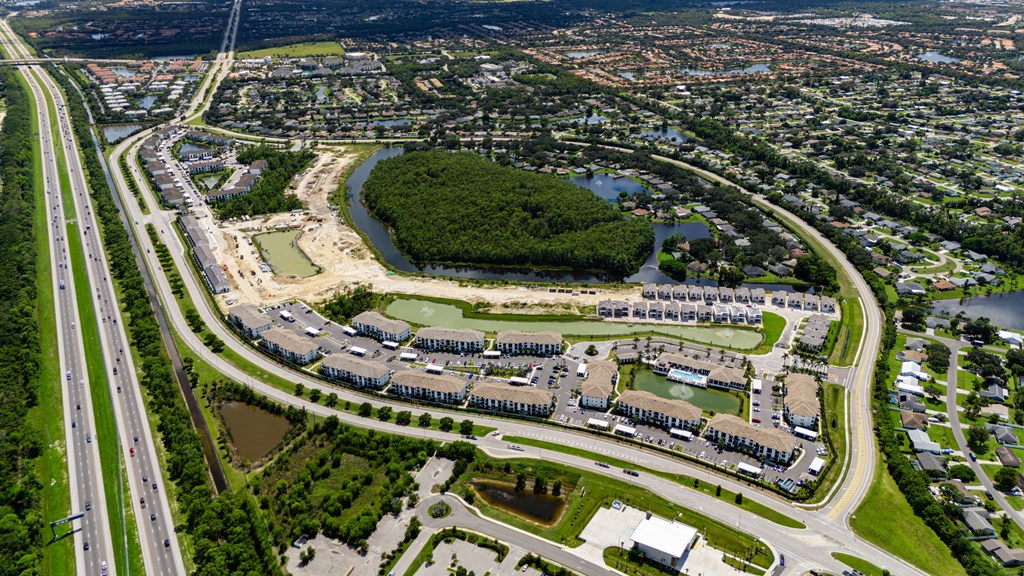 A bird's eye view of a residential area with a river running through it.