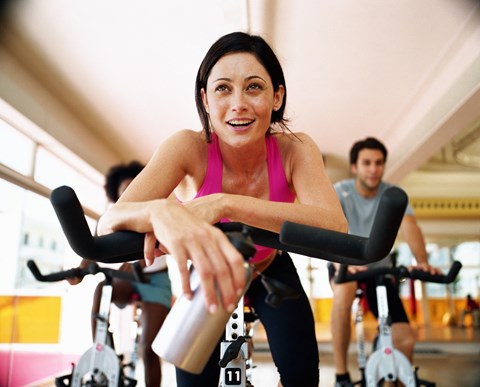 a woman cycling on an exercise bike at a gym a woman cycling on an exercise bike at a gym at The Falls of Portofino Apartment, Naples, FL