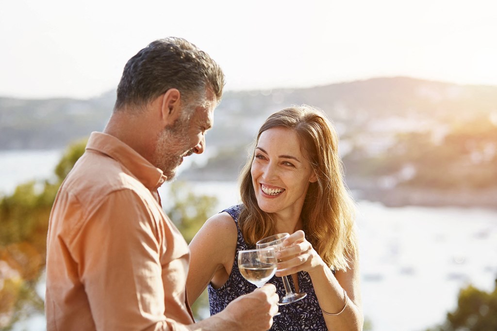 a man and a woman holding a glass of wine at The Falls of Portofino Apartment, Naples