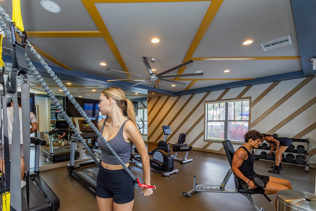A woman is working out on a treadmill in a gym.