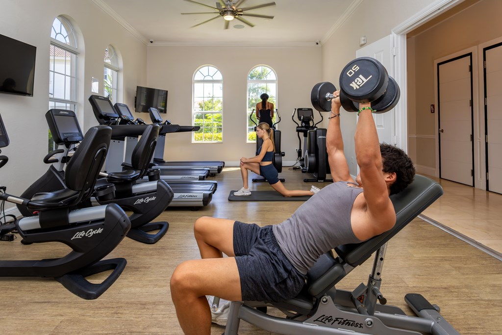 A man lifting weights in a home gym.