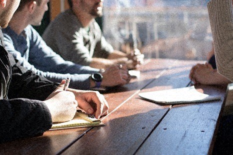 a group of people sitting at a table