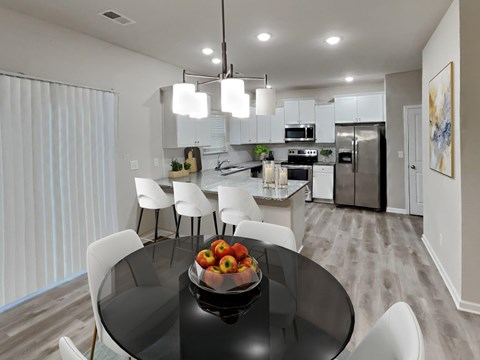 A modern kitchen with a glass table and white chairs.