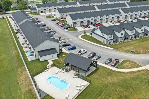 A large building with a pool in front of it.