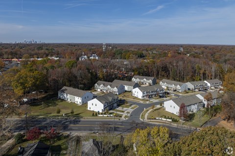 A bird's eye view of a residential area with houses and trees.