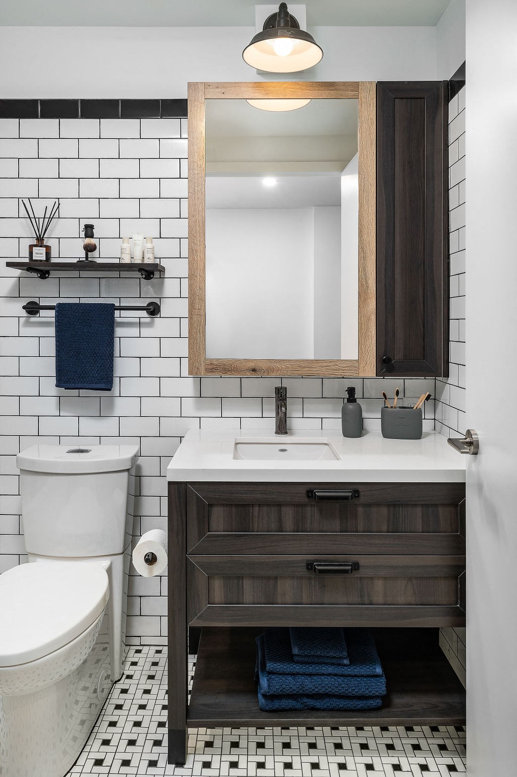 a bathroom with a toilet and a sink and a mirror