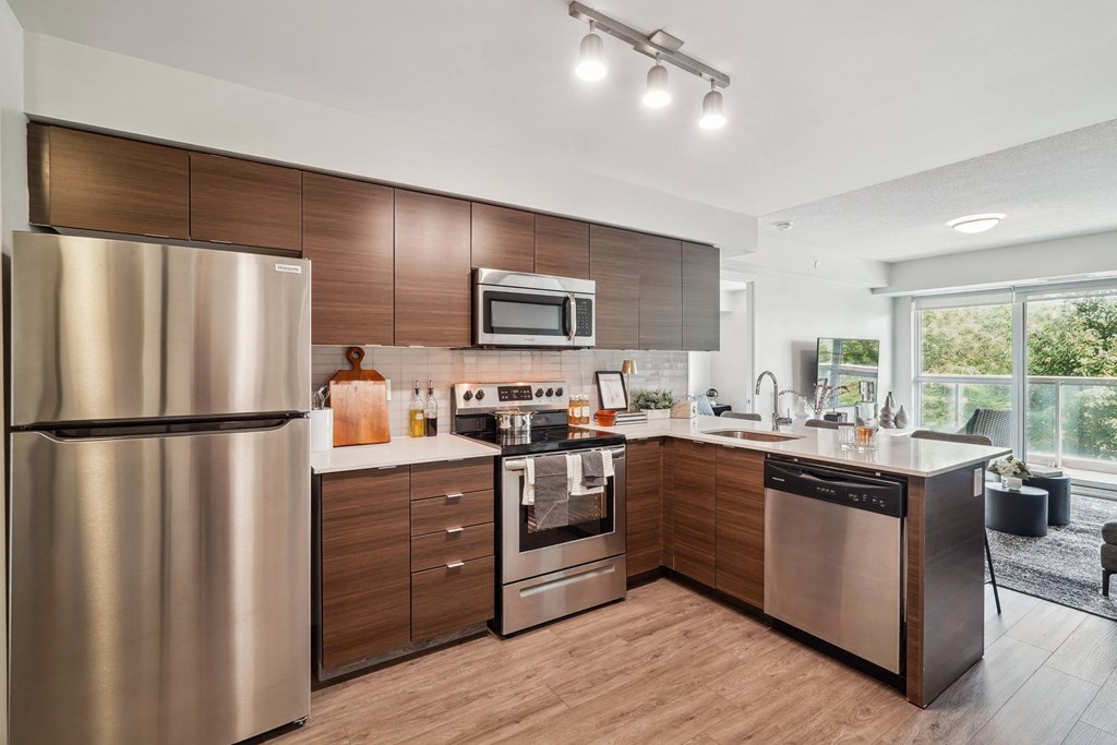 a kitchen with stainless steel appliances and wooden cabinets