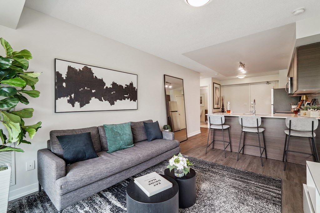 a living room with a couch and a kitchen in the background