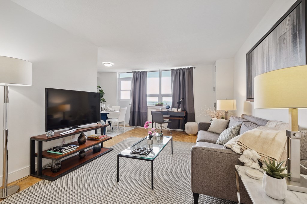 a living room with a couch and a coffee table and a television