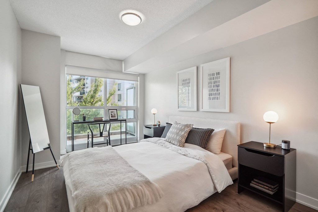 a bedroom with a large bed and a large window