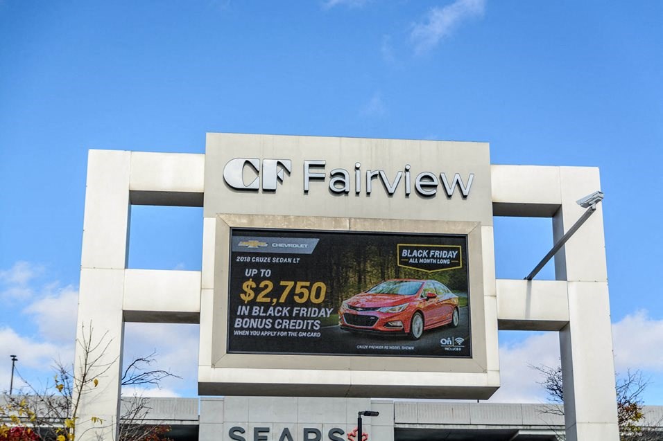 a sign for a car dealership on the side of a building