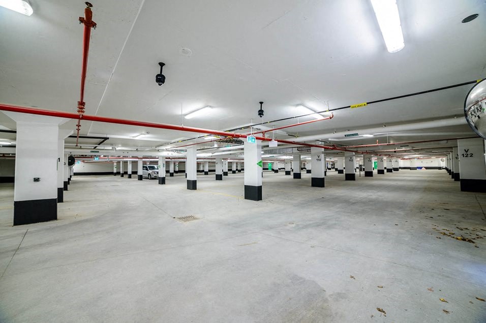 the inside of a parking garage with rows of columns