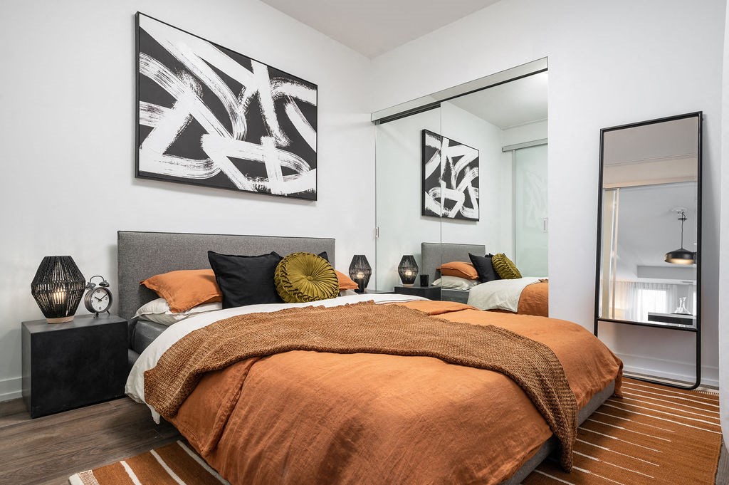 a bedroom with a bed and a mirror