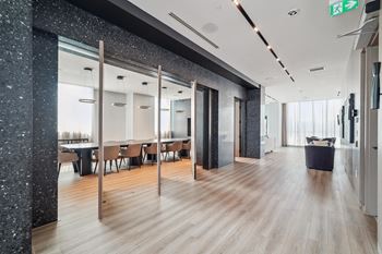a large room with tables and mirrors and a wood floor