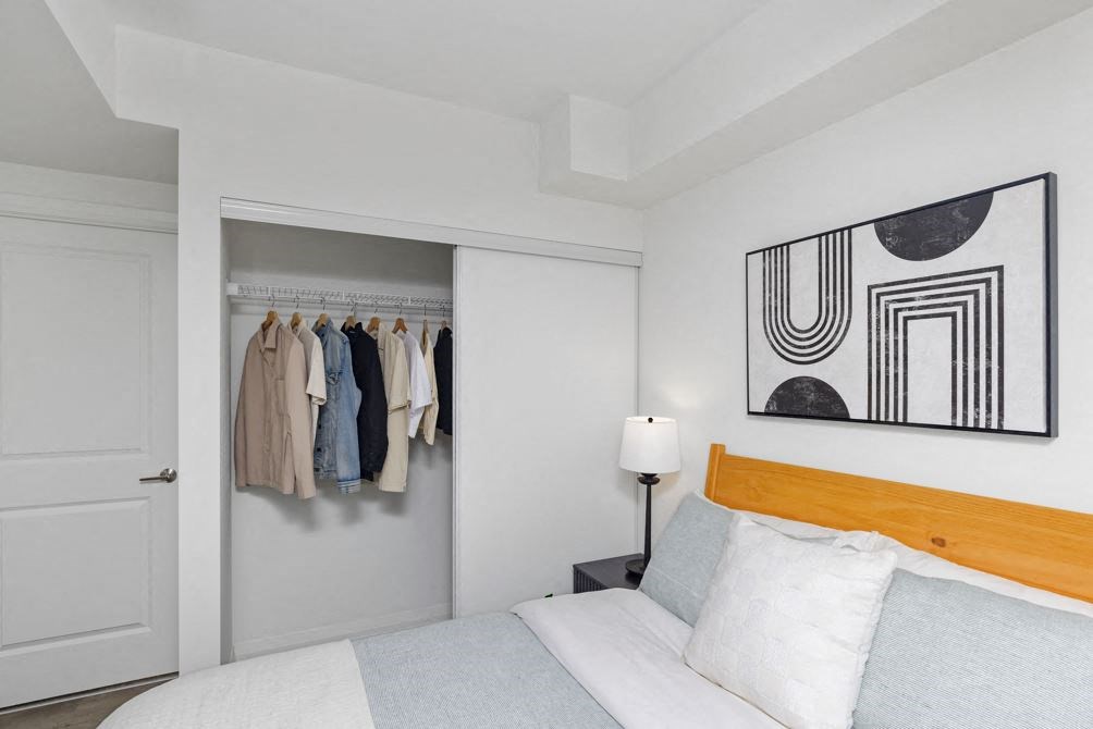 a bedroom with a bed and a closet