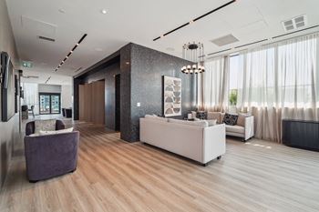a lobby with couches and chairs and a reception desk
