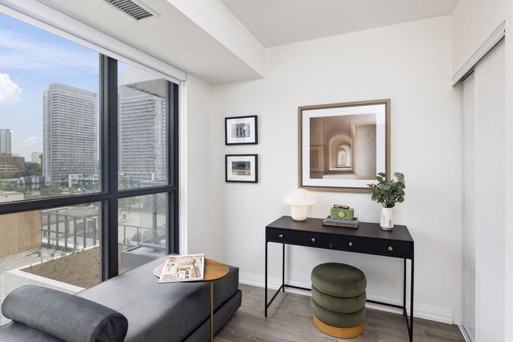 a living room with a couch and a table and a window