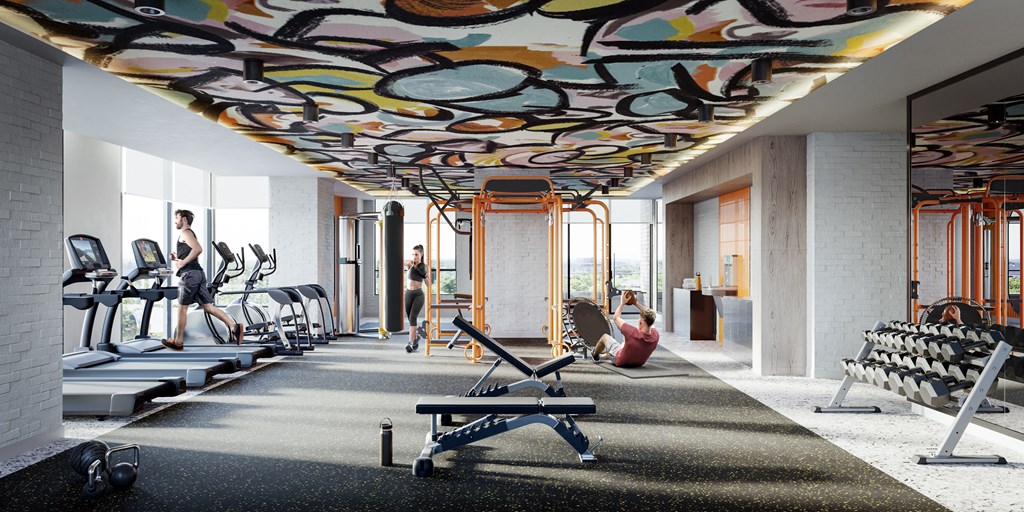 a gym with a mural on the ceiling and people exercising in it